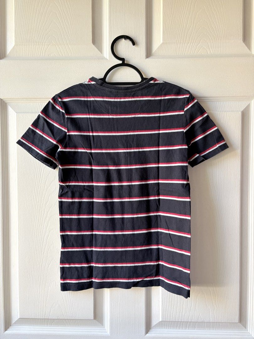 Original Penguin Striped T-Shirt (Category: Babies & Kids Fashion) located in Liloan. Submitted by mrs.jboiser (Listing ID 1469211660, Image 2). Description: - Brand: Original Penguin - Size: 10-11 Years - Color: Navy blue, red, and white stripes - Design: Crew neck, short sleeves, and embroidered penguin logo on the chest - Fit: Regular fit - Condition: Great casual everyday tee.