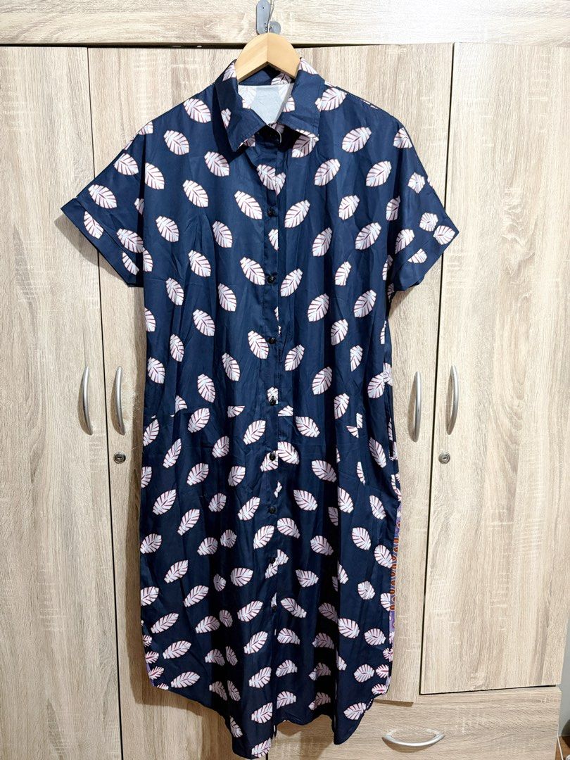 Oversized / Plus Size Navy Blue Leaf Print Button Down Midi Dress (Category: Dresses) located in Manila. Submitted by topsh0ppe (Listing ID 1469215332, Image 1). Description: - Color & Print: Navy blue with an all-over white leaf print and a vibrant mandala pattern on the lower back hem - Design: Short sleeves, lapel collar, and front button-down closure - Material: Lightweight, breathable fabric perfect for effortless everyday styling - Fit & St