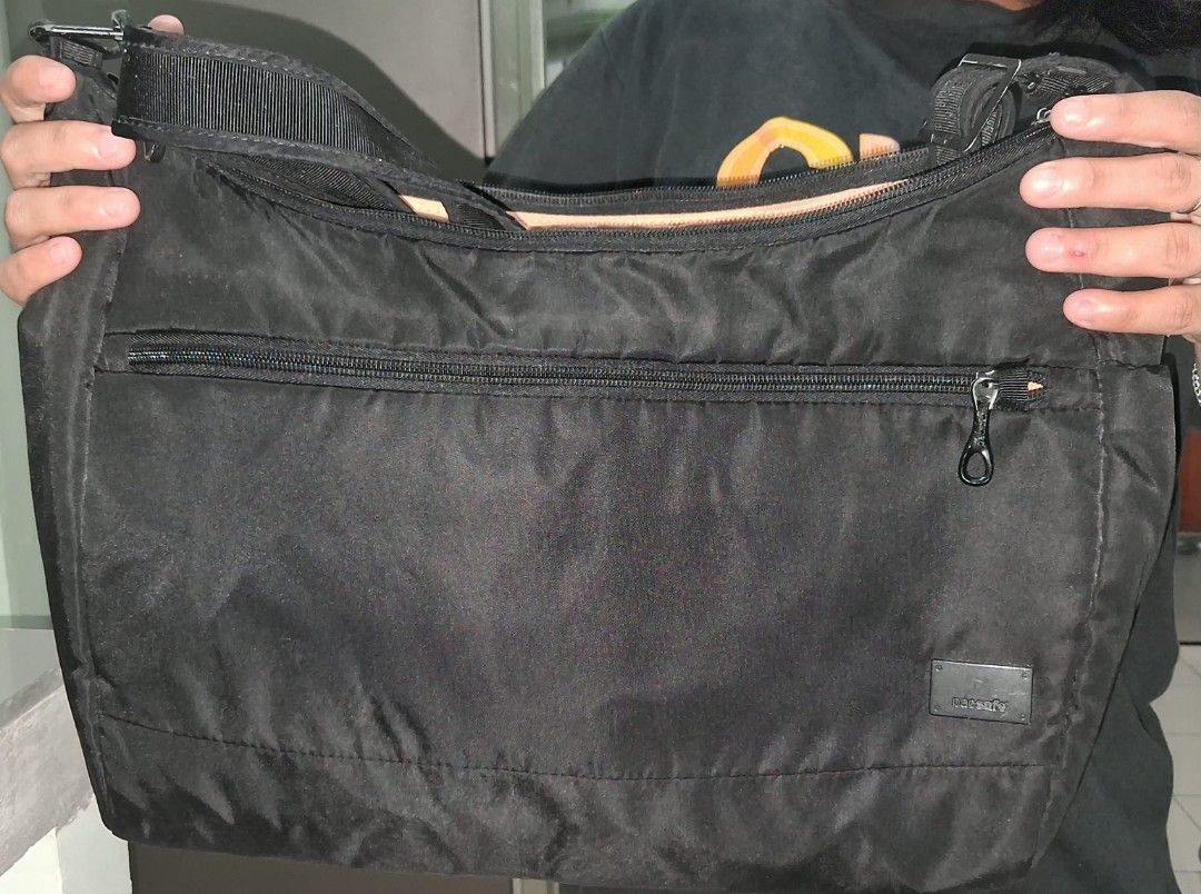Pacsafe Black Anti-Theft Shoulder Bag (Category: Laptop Bags & Sleeves) located in Mandaluyong City. Submitted by gantan.tree (Listing ID 1469235654, Image 1). Description: - Brand/Model: Pacsafe Anti-Theft Shoulder Bag (Black) size: 15" X 10.5" X 4" strap 30" (shortest length) - Exterior: Durable nylon / secure zippered front pocket and side pocket - Interior: Light beige lining with organized pockets and RFID-safe compartments - Security: Equip