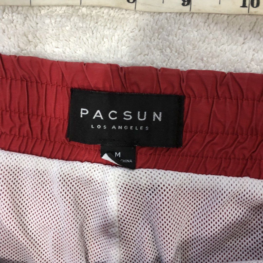 Pacsun Red Drawstring Swim Shorts Size M (Category: Swim Trunks & Board Shorts) located in Manila. Submitted by janmichael26601 (Listing ID 1469206967, Image 3). Description: - Brand: Pacsun - Color: Red - Size: Medium - Material: Comfortable cotton and nylon blend - Details: White drawstring waist, white inner mesh lining, and a right-side back pocket - Condition: Good for casual beach wear, with a few notable dark spots and stains on the lower 