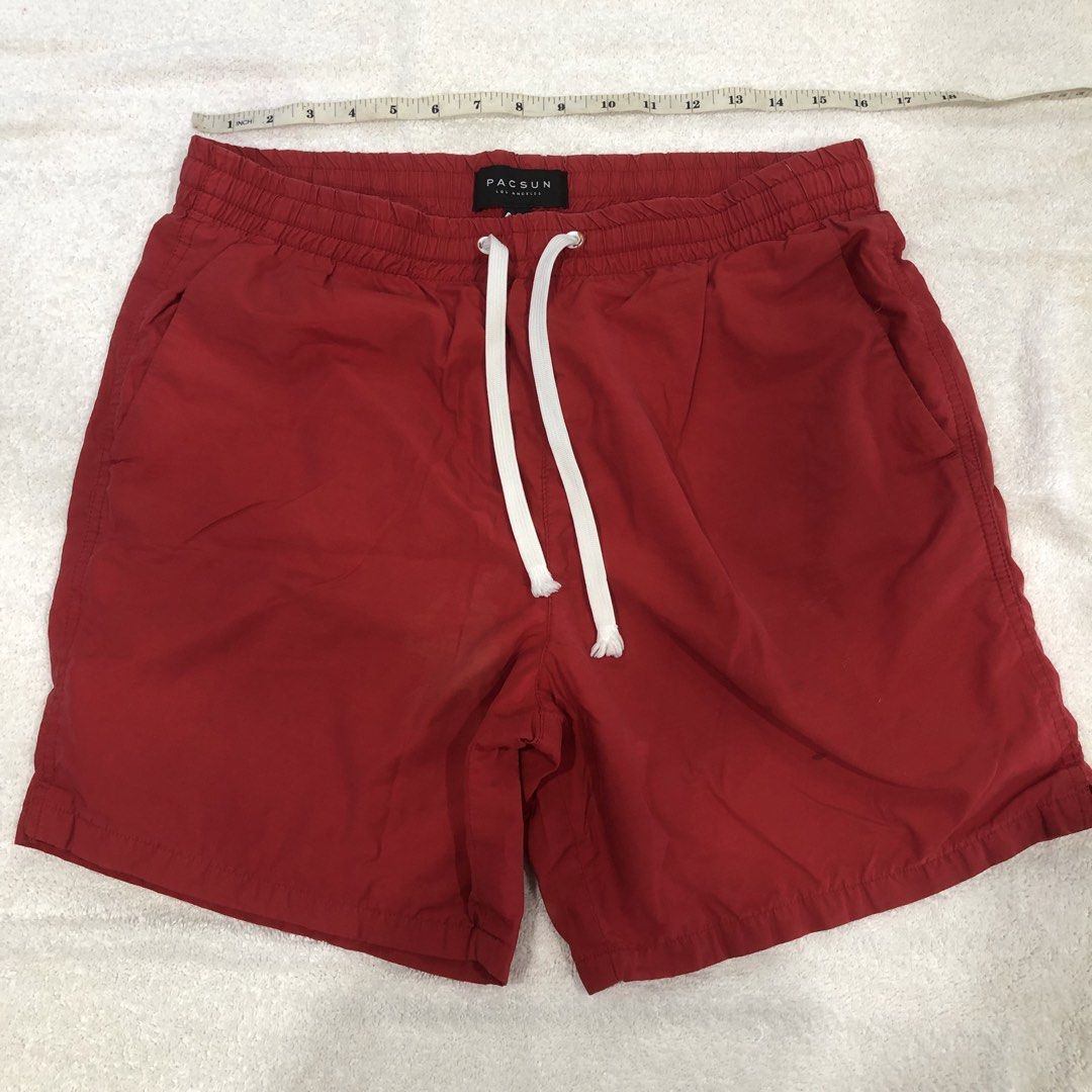 Pacsun Red Drawstring Swim Shorts Size M (Category: Swim Trunks & Board Shorts) located in Manila. Submitted by janmichael26601 (Listing ID 1469206967, Image 1). Description: - Brand: Pacsun - Color: Red - Size: Medium - Material: Comfortable cotton and nylon blend - Details: White drawstring waist, white inner mesh lining, and a right-side back pocket - Condition: Good for casual beach wear, with a few notable dark spots and stains on the lower 