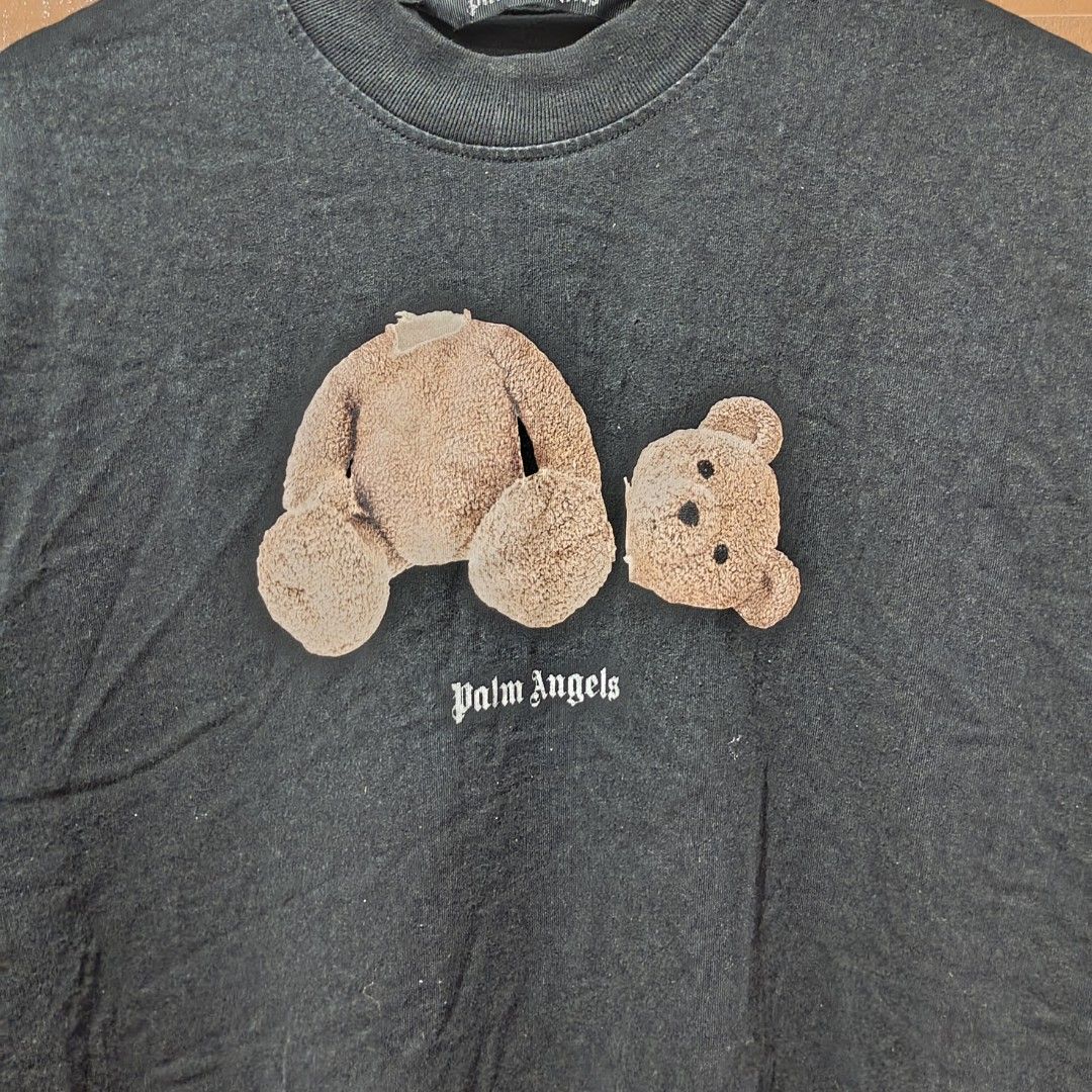 Palm Angels Bear Graphic Tee Black Oversized (Category: Tshirts & Polo Shirts ) located in Clarin. Submitted by thrftpngsnihan25 (Listing ID 1469164926, Image 2). Description: - Brand: Palm Angels - Color: Dark washed black - Design: Iconic headless bear graphic with classic gothic logo - Fit: Trendy oversized fit with short sleeves and ribbed crewneck - Material: Premium heavy cotton feel - Condition: Brand new with tags - Meet-ups and nationwid