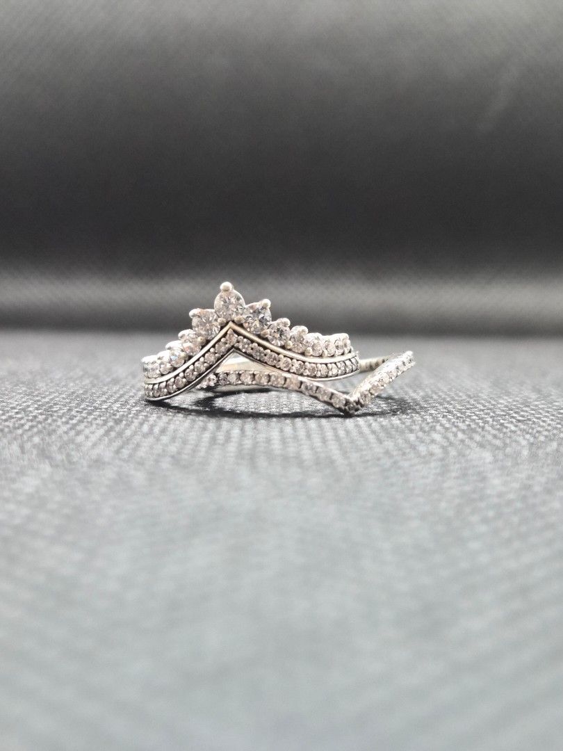 Pandora Princess & Sparkling Wishbone Ring [2 rings] (Category: Rings) located in Manila. Submitted by prelovedbyc.hannah (Listing ID 1469334163, Image 3). Description: - Brand: Pandora - Model: Princess & Sparkling Wishbone Ring - Design: 2 pieces V-shaped crown design with sparkling cubic zirconia stones - Size: European 52/ US 6 - Material: Sterling silver - Inclusion: Original Pandora gift box - Condition: with tarnishing.