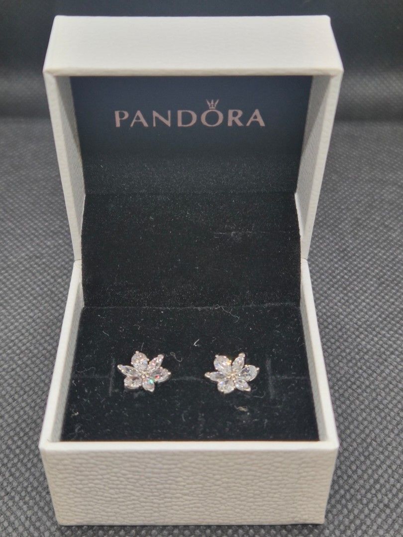 Pandora Sparkling Herbarium Cluster Stud Earrings (Category: Earrings) located in Manila. Submitted by prelovedbyc.hannah (Listing ID 1469335643, Image 2). Description: - Brand: Pandora - Design: Delicate blossoms with sparkling clear cubic zirconia - Hallmark: Stamped with ALE on the back - Inclusions: Original white branded presentation box with black velvet lining - Condition: Clean, well-kept, with butterfly backs attached - Perfect for every