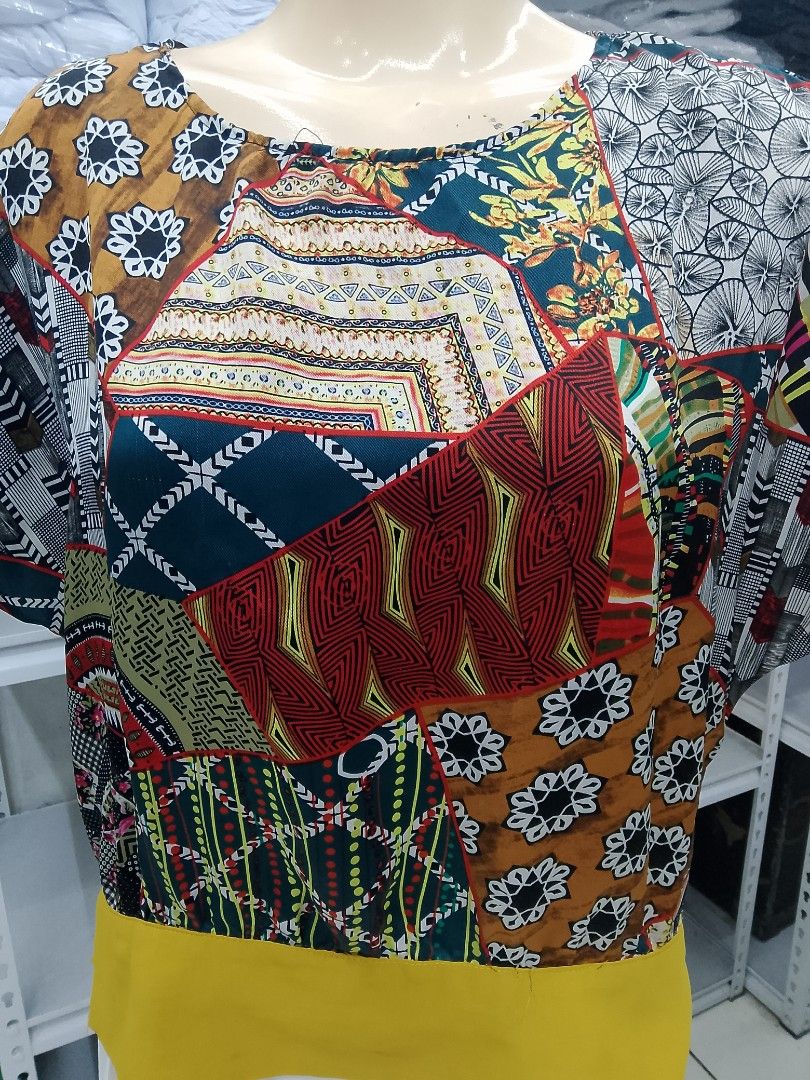 Patchwork Print Short Sleeve Top with Yellow Band Graphic print (Category: Blouses) located in Midsayap. Submitted by jarethshop (Listing ID 1469323598, Image 2). Description: - Style: Short sleeve top with a relaxed, loose fit - Design: Mixed patchwork patterns in brown, red, black, and white with a bright yellow bottom hem - Neckline: Classic round neckline - Fabric: Lightweight and breathable - Versatility: Easy to pair with skirts or trousers