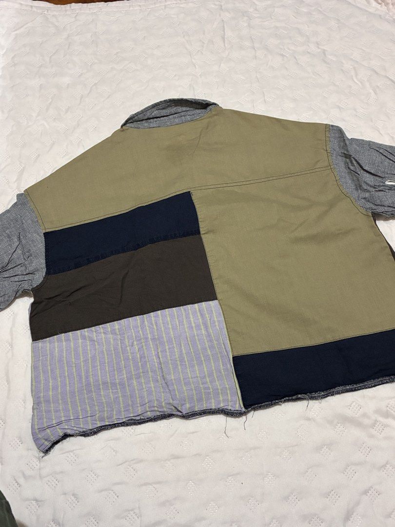 Patchwork Short Sleeve Button Down Shirt Multi-color Whimsical Artsy Y2K (Category: Shirts) located in Quezon City. Submitted by oreosabrinas (Listing ID 1469320788, Image 2). Description: - Style: Patchwork short sleeve button-down shirt - Colors: Olive green, blue, dark brown, and black - Details: Mixed stripe, solid, and check patterns, collared neck, multicolored buttons, and raw hem finish - Fit: Relaxed, boxy fit - Vibe: Perfect statement p
