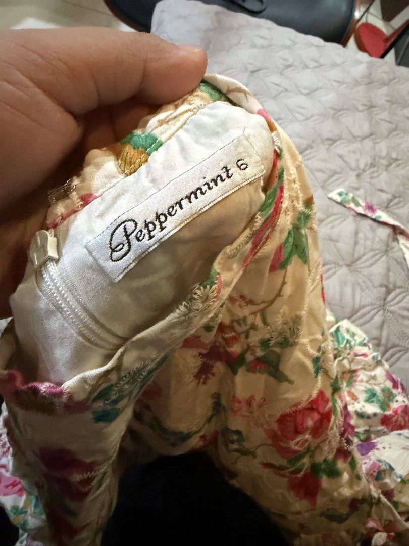 Peppermint floral dress size 6 (Category: Babies & Kids Fashion) located in Paranaque City. Submitted by bperez (Listing ID 1469348421, Image 2). Description: - Cream floral dress with pink, blue, and purple flowers - Features delicate embroidered eyelet pattern throughout - Short puff sleeves and classic round neckline - Convenient back zipper closure - Attached tied belt at the waist for a flattering fit - Tagged Size 6 - Condition: Like new / 