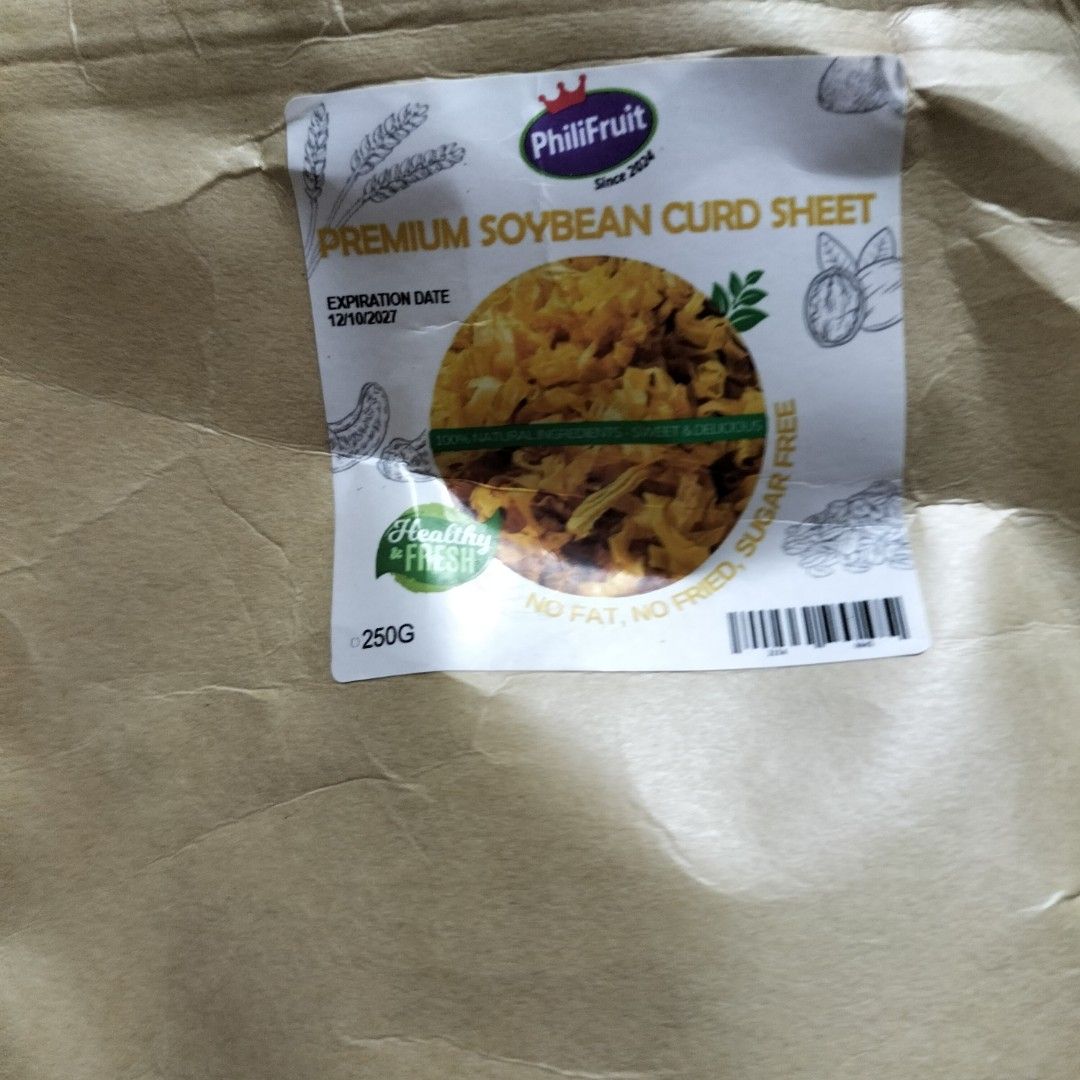 Premium Soybean Curd Sheet 250G (Category: Fresh Produce) located in Paranaque City. Submitted by decluttering-all (Listing ID 1469193182, Image 2). Description: - Product: PhiliFruit Soybean Curd Sheet in flat noodles - Weight: 250g in a brown paper bag with a clear window - Health Benefits: Healthy, fresh, zero fat, non-fried, and sugar-free - Condition: Brand new, sealed, and unopened packaging - Expiration Date: 12/10/2027 p100 per pack of 25