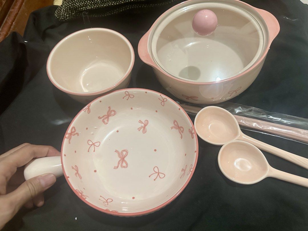 Set Pink bow ceramic tableware set with pot and bowls (Category: Dinnerware & Cutlery) located in Manila. Submitted by shayne2 (Listing ID 1469282908, Image 3). Description: Brand new complete set - Pink and white ceramic dinnerware set with cute ribbon print - Includes lidded pot, large handled bowl, regular bowl, 2 spoons, and chopsticks in wrapper - Features lovely pink rims for an aesthetic dining setup - Clean and ready to use for serving me