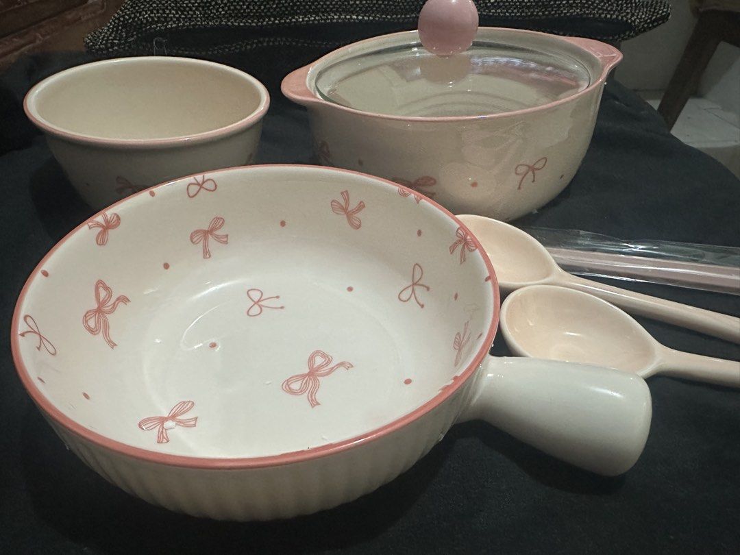 Set Pink bow ceramic tableware set with pot and bowls (Category: Dinnerware & Cutlery) located in Manila. Submitted by shayne2 (Listing ID 1469282908, Image 1). Description: Brand new complete set - Pink and white ceramic dinnerware set with cute ribbon print - Includes lidded pot, large handled bowl, regular bowl, 2 spoons, and chopsticks in wrapper - Features lovely pink rims for an aesthetic dining setup - Clean and ready to use for serving me