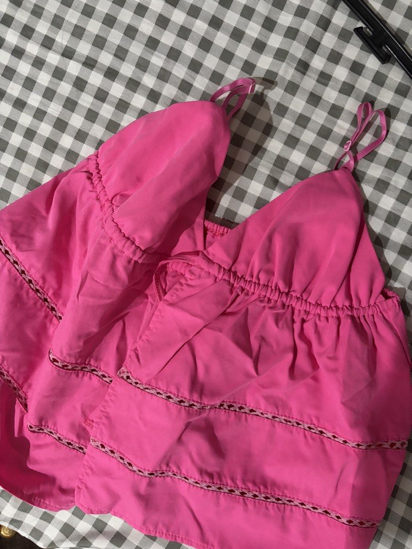 Pink Cami Top with Lace Trim Size M (Category: Sleeveless) located in Quezon City. Submitted by clareb (Listing ID 1469284084, Image 2). Description: - Color: Bright pink - Size: M - Features: Adjustable straps, gathered bust with front tie string, tiered design with open-work lace trim - Material: Lightweight fabric blend (see inner label) - Condition/Origin: Made in China - Style: Great for warm weather or layering.