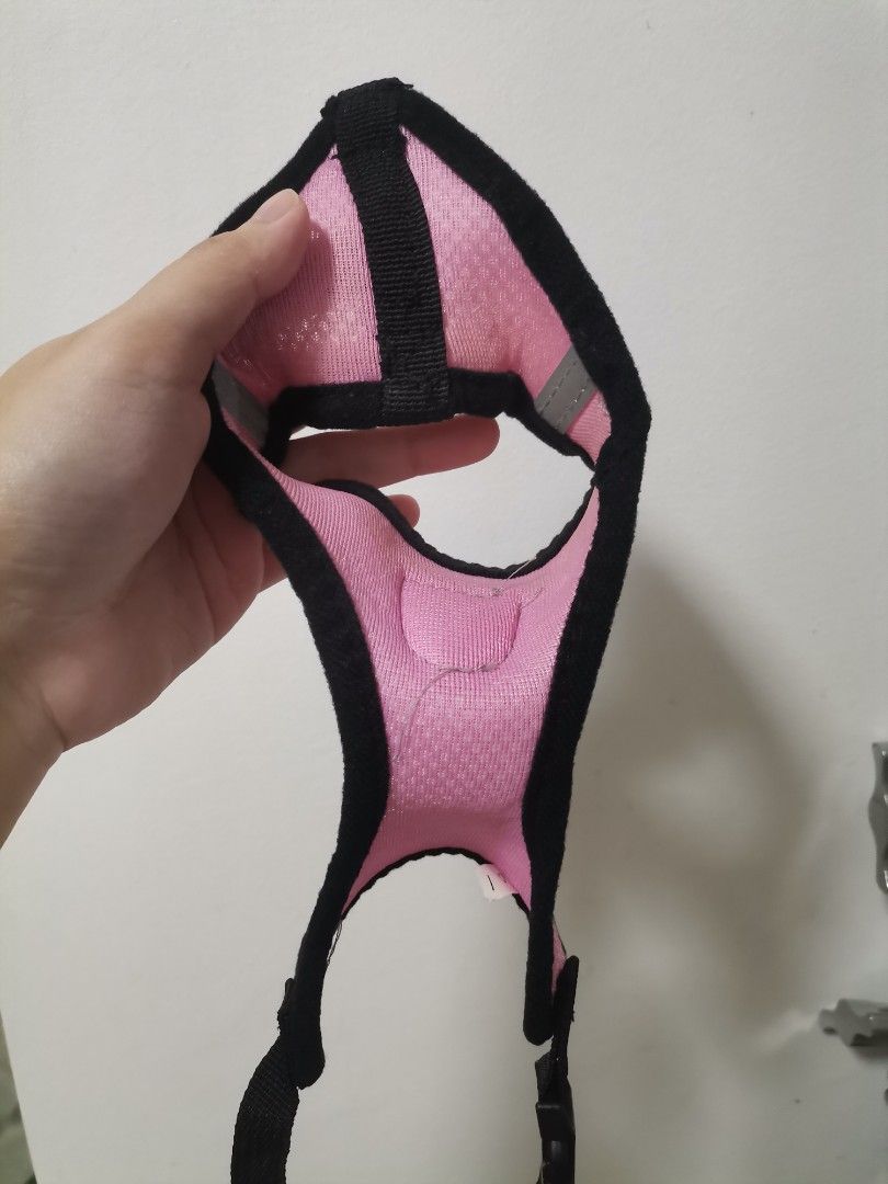 Pink Mesh Pet Harness Size S (Category: Sleeveless) located in Makati City. Submitted by kookybearsstuff (Listing ID 1469278754, Image 3). Description: - Color: Pink with black trim - Size: S (tag attached) - Material: Breathable mesh - Safety: Reflective strips on the sides for night walks - Hardware: Sturdy metal D-ring for leash attachment - Closure: Secure plastic buckle - Details: Adorable paw print badge on the front.