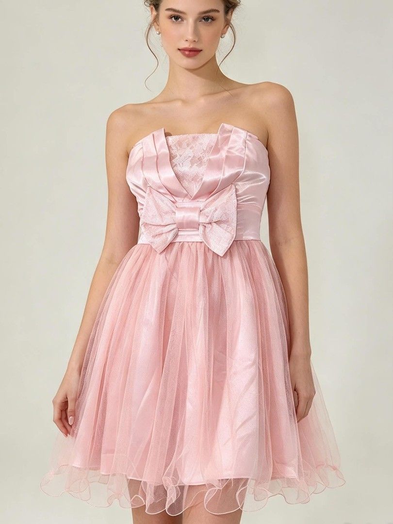 Pink Strapless Tulle Mini Dress With Bow (Category: Dresses) located in Caloocan City. Submitted by prelovedandnewtreasures (Listing ID 1469223456, Image 1). Description: - Color: Light pink - Style: Strapless mini dress (approx. 30 inches long) - Bodice: Satin with a statement front bow and lace accent - Skirt: Fluffy layered tulle with a playful ruffled hem - Fit: Smocked elastic back panel for extra stretch and comfort - Condition: good as new