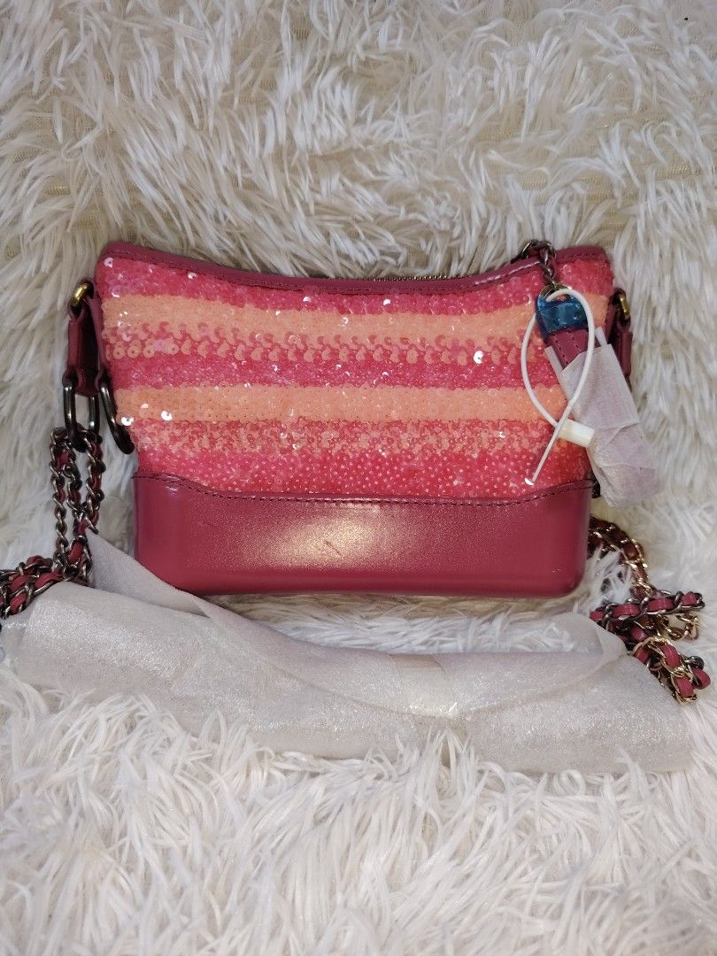 Pink Striped Sequin Shoulder Bag with Chain Strap (Category: Cross-body Bags) located in Quezon City. Submitted by zhelcloset01 (Listing ID 1469321170, Image 1). Description: - Condition: Brand new with tag still attached - Exterior: Pink horizontal sequin stripes with solid pink base and trim - Strap: Gold-tone chain strap (still wrapped in protective foam) - Closure: Secure top zipper - Interior: Bright pink fabric lining with a convenient zipp