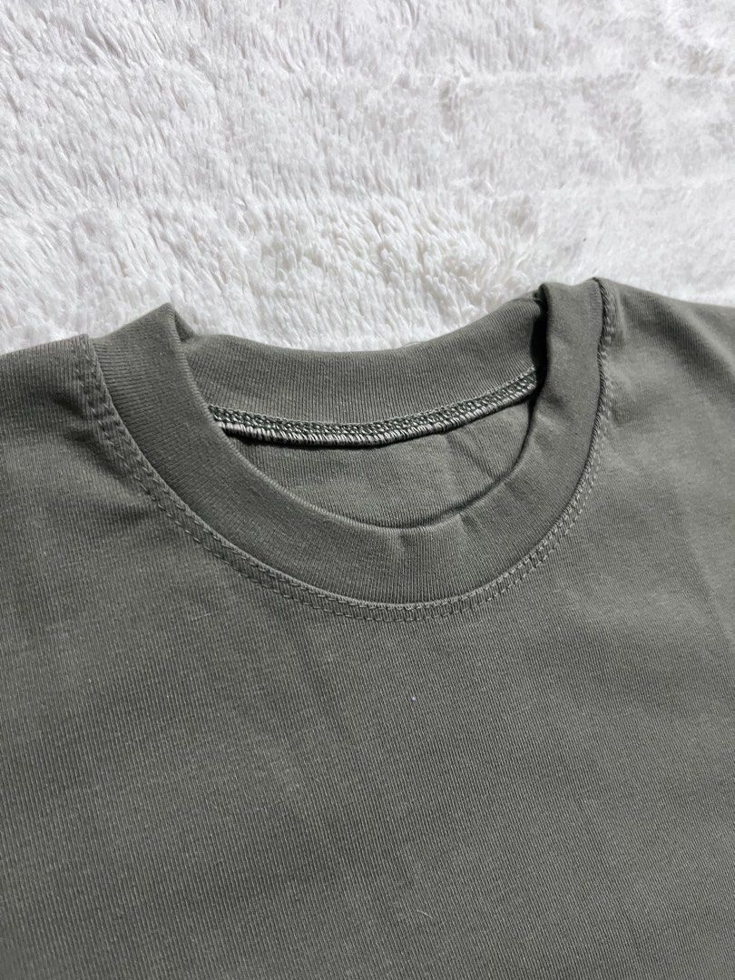 Plain Olive Green Short Sleeve T-Shirt (Category: Shirts) located in Manila. Submitted by kiks_secret_room (Listing ID 1469270197, Image 2). Description: Solid olive green t-shirt with short sleeves and a classic crew neck. Plain front and back design. Clean stitching around the neckline and cuffs. Laid flat, measures roughly 18 inches across the chest and 19 inches in total length. Soft cotton-blend fabric, everyday basic style. Neutral earth to