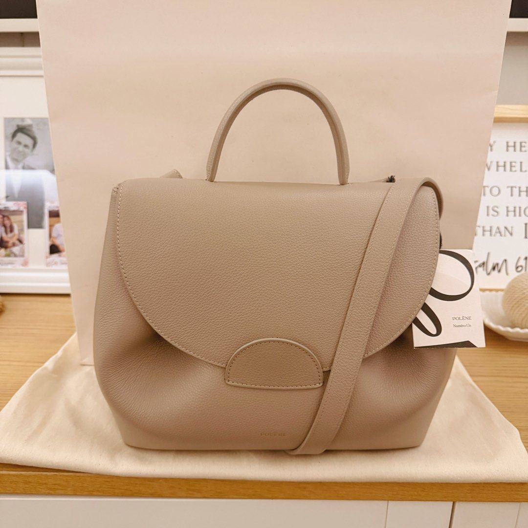 polene numero un (Category: Shoulder Bags) located in Quezon City. Submitted by gutchiboi (Listing ID 1469283921, Image 2). Description: Authentic Polène Numéro Un – Textured Taupe Purchased personally by my wife in Paris in 2025. One of Polène’s signature designs, crafted from textured Italian calf leather, featuring sculpted folds, a rounded flap, classic top handle, and detachable shoulder strap. Condition: Mint / Pristine. The front button cl