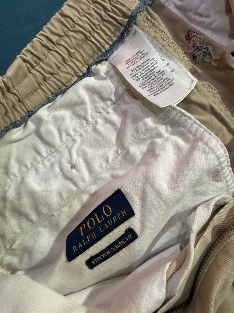 Polo Ralph Lauren Hula Dancer Palm Tree Shorts (Category: Shorts) located in Manila. Submitted by rojotesoro (Listing ID 1469229873, Image 3). Description: - Brand: Polo Ralph Lauren - Style: Stretch classic fit shorts with elastic waistband and zipper fly - Color: Tan khaki - Design: Unique all-over hula dancer and palm tree embroidered pattern, with signature pony logo near hem - Material: Comfortable cotton and elastane blend - Ideal for: Summ