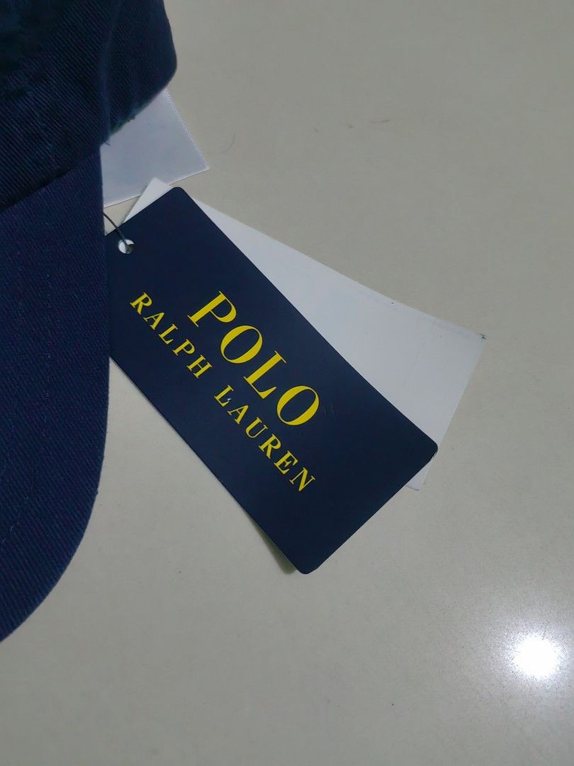 Polo Ralph Lauren Navy Blue Cap (Category: Caps & Hats) located in Las Pinas. Submitted by huslerz (Listing ID 1469260326, Image 3). Description: - Brand: Polo Ralph Lauren - Color: Classic navy blue with yellow embroidered pony logo - Material: 100% comfortable cotton for everyday wear - Size: One size fits all with adjustable back strap - Condition: Brand new with original tags still attached.