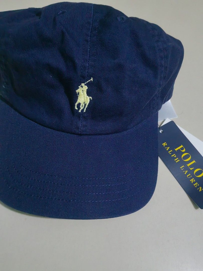 Polo Ralph Lauren Navy Blue Cap (Category: Caps & Hats) located in Las Pinas. Submitted by huslerz (Listing ID 1469260326, Image 2). Description: - Brand: Polo Ralph Lauren - Color: Classic navy blue with yellow embroidered pony logo - Material: 100% comfortable cotton for everyday wear - Size: One size fits all with adjustable back strap - Condition: Brand new with original tags still attached.