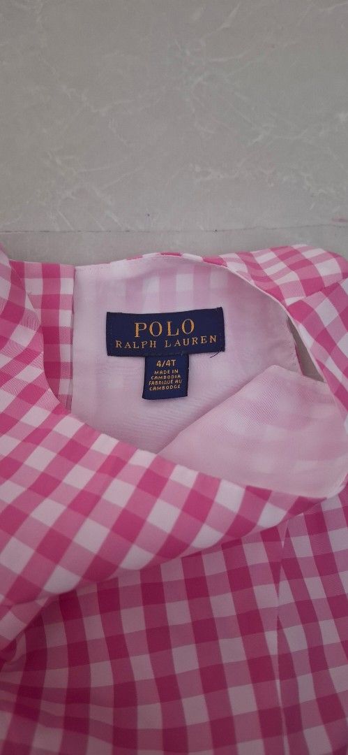 Polo Ralph Lauren Pink Gingham Dress Size 4T (Category: Babies & Kids Fashion) located in Pasay City. Submitted by al1son18 (Listing ID 1469196549, Image 2). Description: - Brand: Polo Ralph Lauren - Size: 4T (Made in Cambodia) - Design: Classic pink and white gingham pattern, sleeveless, flared skirt - Closure: Slip-on style with a hidden back button closure - Condition: Clean, well-kept, and gently used - Perfect for: Everyday wear, parties, an