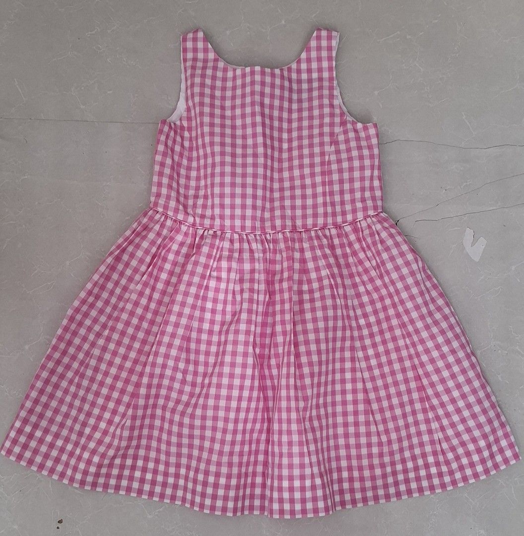 Polo Ralph Lauren Pink Gingham Dress Size 4T (Category: Babies & Kids Fashion) located in Pasay City. Submitted by al1son18 (Listing ID 1469196549, Image 1). Description: - Brand: Polo Ralph Lauren - Size: 4T (Made in Cambodia) - Design: Classic pink and white gingham pattern, sleeveless, flared skirt - Closure: Slip-on style with a hidden back button closure - Condition: Clean, well-kept, and gently used - Perfect for: Everyday wear, parties, an