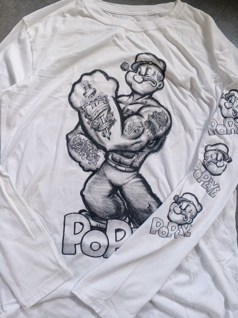 Popeye Long Sleeve Graphic Tee White Size L (Category: Tshirts & Polo Shirts ) located in Manila. Submitted by pescadorvi14235 (Listing ID 1469225911, Image 3). Description: - Design: Large Popeye graphic on the front with tattooed arms and repeated graphics down the sleeve - Color: White Excellent Condition Color Rate:9.5/10 Issue:None Dimes:20x27 Location: Pangasinan, Luzon.