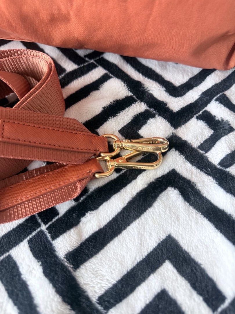 Prada nylon tote bag orange with strap (Category: Luxury Bags & Wallets) located in Pasig City. Submitted by sherill888 (Listing ID 1469338273, Image 2). Description: - Authentic Prada orange nylon tote bag - Saffiano leather trim & gold-tone hardware - Iconic front triangle logo plaque - Matching top handles & detachable crossbody strap for versatile wear - Secure top zip closure - Signature Prada fabric-lined interior with a roomy everyday size