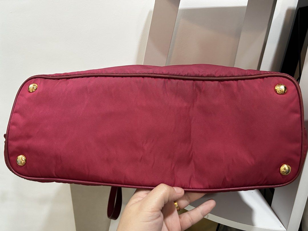 Prada Nylon Tote Bag Red Gold Hardware (Category: Luxury Bags & Wallets) located in Rizal. Submitted by bebangel (Listing ID 1469279074, Image 3). Description: - Authentic Red Prada tote bag - Durable nylon material with matching leather trim - Elegant gold-tone hardware & iconic Prada logo lettering - Dual shoulder straps & chic side drawstring accents - Protective metal feet on the bottom base - Spacious interior compartment, perfect for daily 