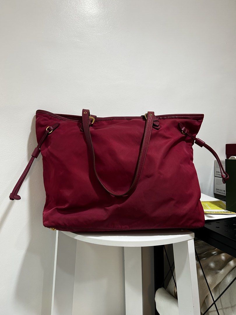 Prada Nylon Tote Bag Red Gold Hardware (Category: Luxury Bags & Wallets) located in Rizal. Submitted by bebangel (Listing ID 1469279074, Image 2). Description: - Authentic Red Prada tote bag - Durable nylon material with matching leather trim - Elegant gold-tone hardware & iconic Prada logo lettering - Dual shoulder straps & chic side drawstring accents - Protective metal feet on the bottom base - Spacious interior compartment, perfect for daily 