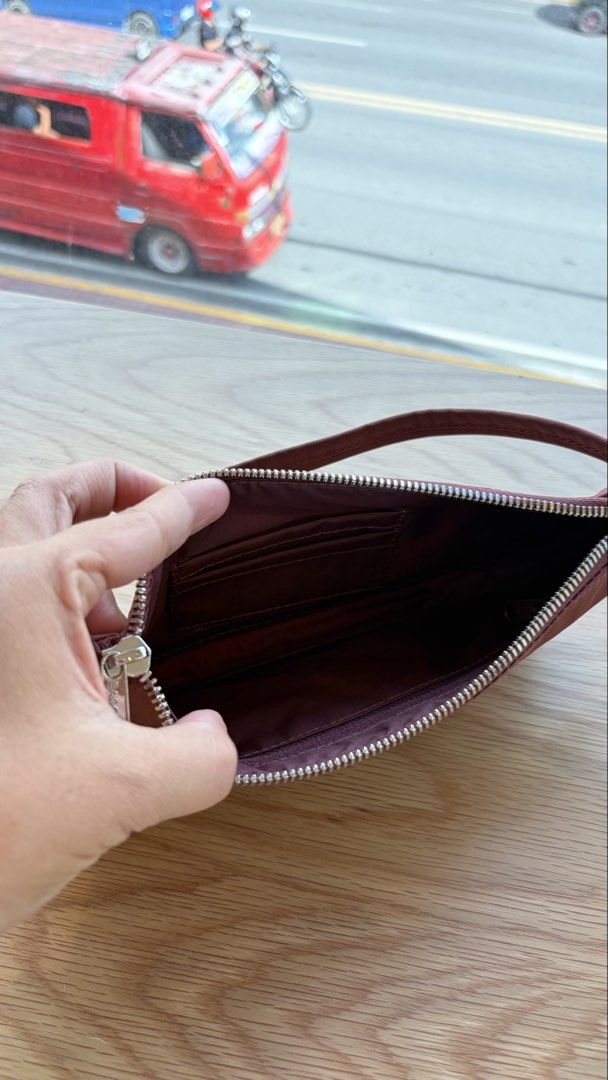 PRELOVED BAGGU NYLON POCHETTE (Category: Shoulder Bags) located in Cebu City. Submitted by kyarahmae (Listing ID 1469163785, Image 3). Description: - Color/Material: Durable maroon nylon - Closure: Top zipper with metal pull - Interior: Lined compartment with built-in card slots - Size: Compact yet spacious enough for daily essentials - Style: Simple, minimalist design ideal for casual everyday use.