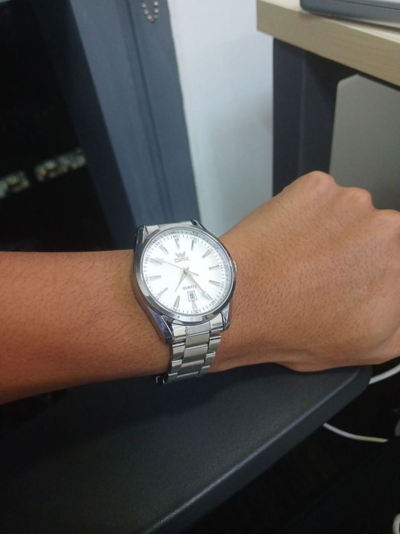 Preloved CSK Quartz Watch Silver (Category: Men's Watches) located in Taguig. Submitted by joshuaseziba (Listing ID 1469272587, Image 2). Description: Selling this CSK Quartz Watch with a classic silver-tone design. • Silver-tone stainless steel case and bracelet. • White dial with clear hour markers and a date window. • Visible minor scratches on the bracelet and case, consistent with regular wear. • Crystal appears clean with no major scratches