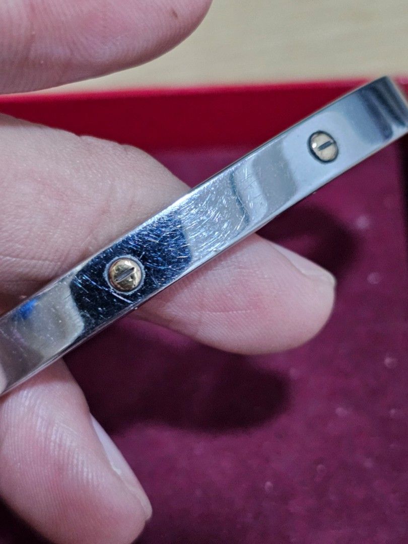 Pre-loved Silver-toned bangle bracelet (Category: Bracelets) located in Caloocan City. Submitted by smart_shoppers_ville (Listing ID 1469172402, Image 2). Description: - Silver-toned bangle with trendy gold screw accents - Easy hinged opening for quick wear - Stainless steel interior stamp - Great for everyday styling and stacking - Has visible surface scratches from normal daily wear.