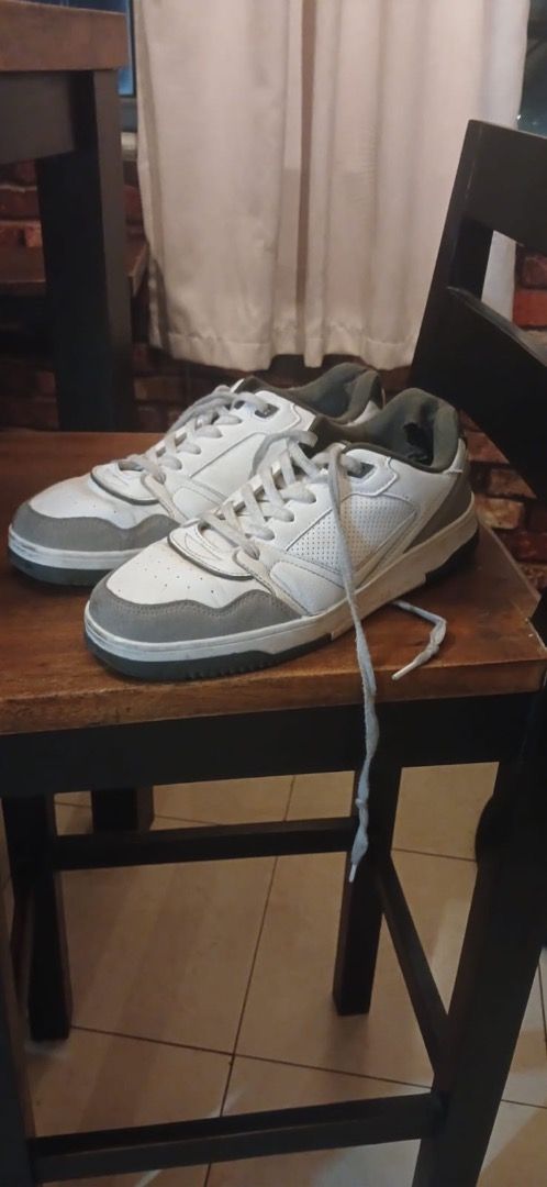 Preloved White and Grey Sneakers (Category: Sneakers) located in Taguig. Submitted by joshuaseziba (Listing ID 1469213963, Image 2). Description: Preloved white and grey sneakers. • White upper with grey accents and soles • Standard lace-up closure • Visible wear on the soles and some discoloration on the laces • No major rips or tears visible • Suitable for casual everyday use This item is in Used – good condition — selling because Decluttering.