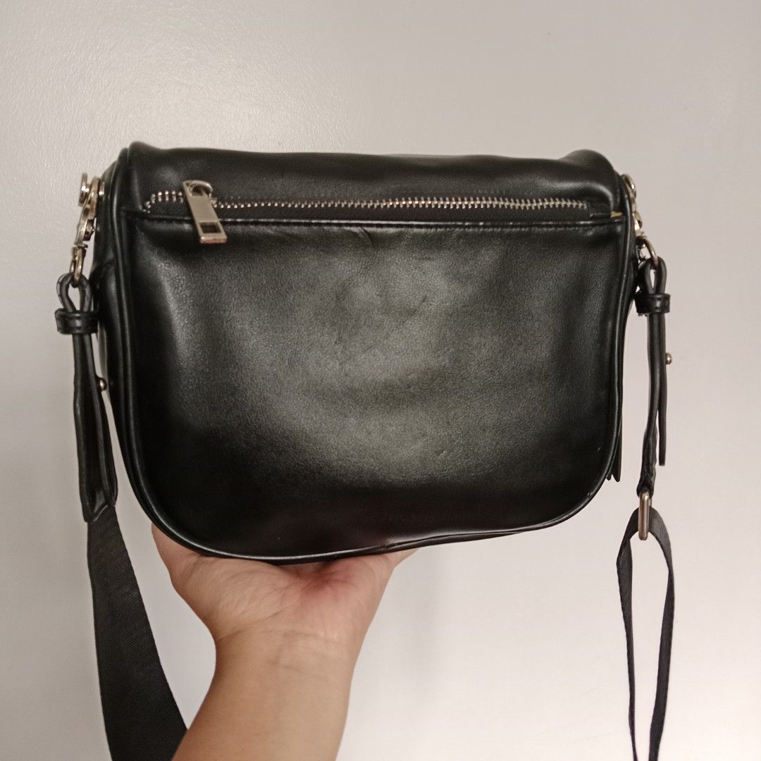 Pre-owned Men's Bag (Category: Belt bags, Clutches and Pouches) located in Manila. Submitted by mamapards17 (Listing ID 1469186952, Image 3). Description: black leather belt bag / crossbody sling bag features a soft silhouette, a front zippered pocket with long leather pull tabs, a top zip closure, and a wide, adjustable webbed shoulder strap..