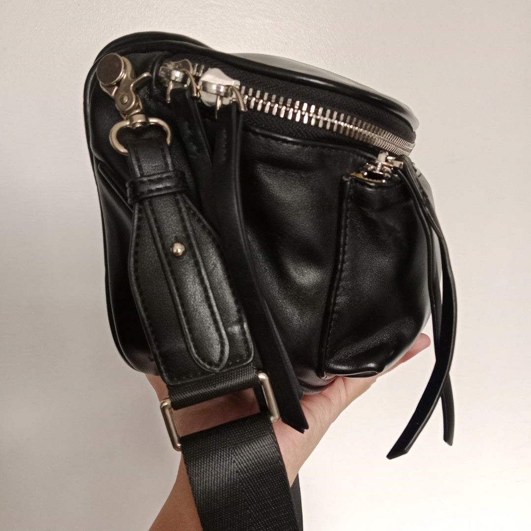 Pre-owned Men's Bag (Category: Belt bags, Clutches and Pouches) located in Manila. Submitted by mamapards17 (Listing ID 1469186952, Image 2). Description: black leather belt bag / crossbody sling bag features a soft silhouette, a front zippered pocket with long leather pull tabs, a top zip closure, and a wide, adjustable webbed shoulder strap..