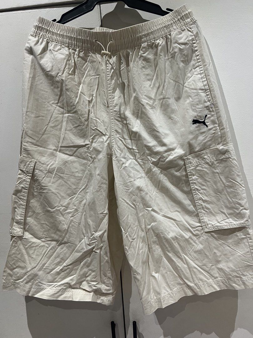 Puma Cream Ripstop Cargo Shorts with Drawstring (Category: Shorts) located in Quezon City. Submitted by Zandee (Listing ID 1469308224, Image 1). Description: - Brand/Style: Cream colored Puma cargo shorts - Material: Lightweight and durable ripstop fabric - Fit: Relaxed, knee-length style for everyday comfort - Waistband: Elastic with adjustable drawstring and toggle - Pockets: Two side pockets plus functional cargo pockets on each leg - Branding