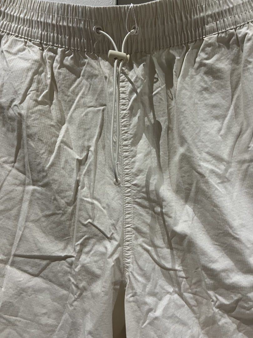 Puma Cream Ripstop Cargo Shorts with Drawstring (Category: Shorts) located in Quezon City. Submitted by Zandee (Listing ID 1469308224, Image 3). Description: - Brand/Style: Cream colored Puma cargo shorts - Material: Lightweight and durable ripstop fabric - Fit: Relaxed, knee-length style for everyday comfort - Waistband: Elastic with adjustable drawstring and toggle - Pockets: Two side pockets plus functional cargo pockets on each leg - Branding
