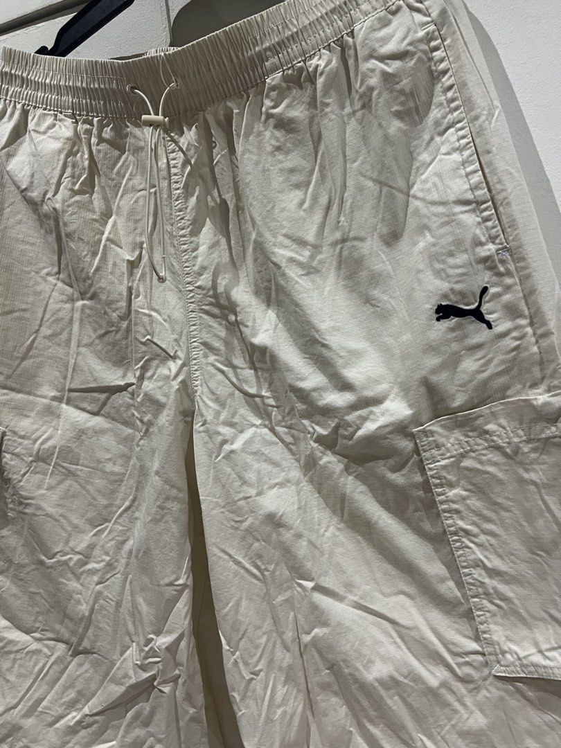 Puma Cream Ripstop Cargo Shorts with Drawstring (Category: Shorts) located in Quezon City. Submitted by Zandee (Listing ID 1469308224, Image 2). Description: - Brand/Style: Cream colored Puma cargo shorts - Material: Lightweight and durable ripstop fabric - Fit: Relaxed, knee-length style for everyday comfort - Waistband: Elastic with adjustable drawstring and toggle - Pockets: Two side pockets plus functional cargo pockets on each leg - Branding