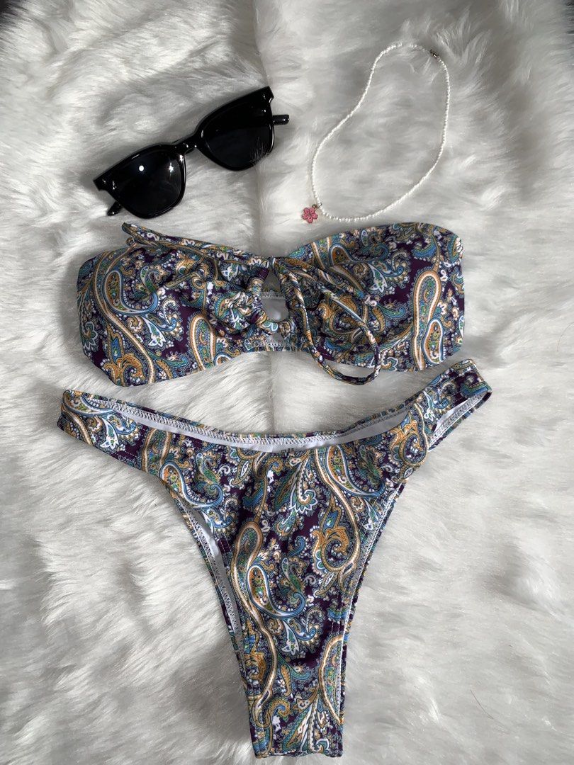 Purple Paisley Print Two-Piece Bikini Set (Category: Bikinis & Swimsuits) located in Mandaluyong City. Submitted by gentle.segoviajam (Listing ID 1469323406, Image 1). Description: Gorgeous purple paisley two-piece bikini featuring a bandeau twist-knot top and high-cut cheeky bottoms. Soft, stretchy fabric with white lining. Perfect for your next beach trip or pool day! Brand new and ready to ship..