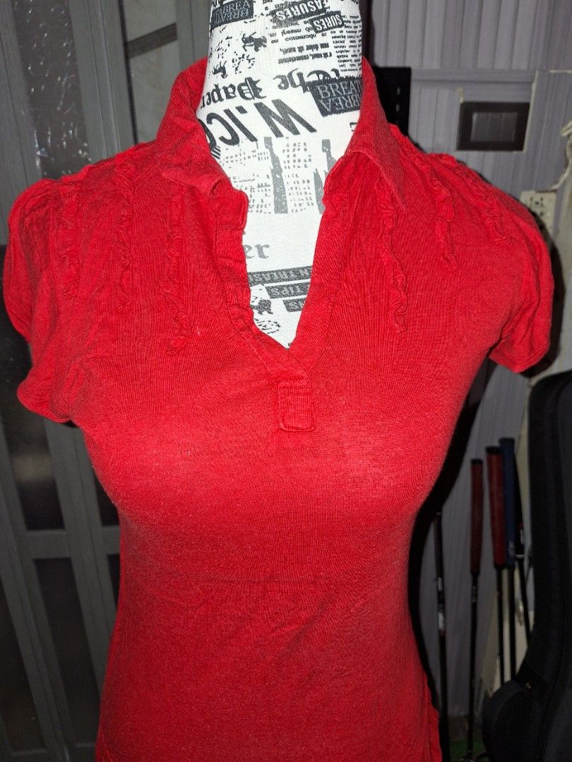 Red Ruffled V-Neck Short Sleeve Tunic Top (Category: Blouses) located in Manila. Submitted by mialiurshop (Listing ID 1469228374, Image 2). Description: - Color: Bright red - Style: Short sleeve tunic top with flared peplum bottom tier - Details: Ruffled trim along V-neckline, sleeves, and dropped waist hem - Material: Ribbed stretch fabric for a comfortable fit.