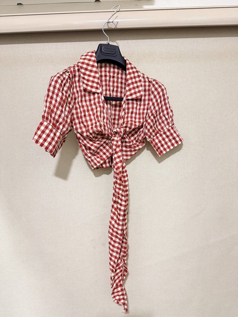Red White Gingham Check Crop Tie Blouse (Category: Blouses) located in Cavite. Submitted by mgd.blessed (Listing ID 1469314476, Image 1). Description: - Style: Red and white gingham crop top with a picnic-ready vibe - Design: Deep V-neck, short sleeves with gathered shoulders, and long front ties - Fit & Pairing: Great with high-waisted denim or skirts - Fabric: Lightweight and perfect for summer wear.