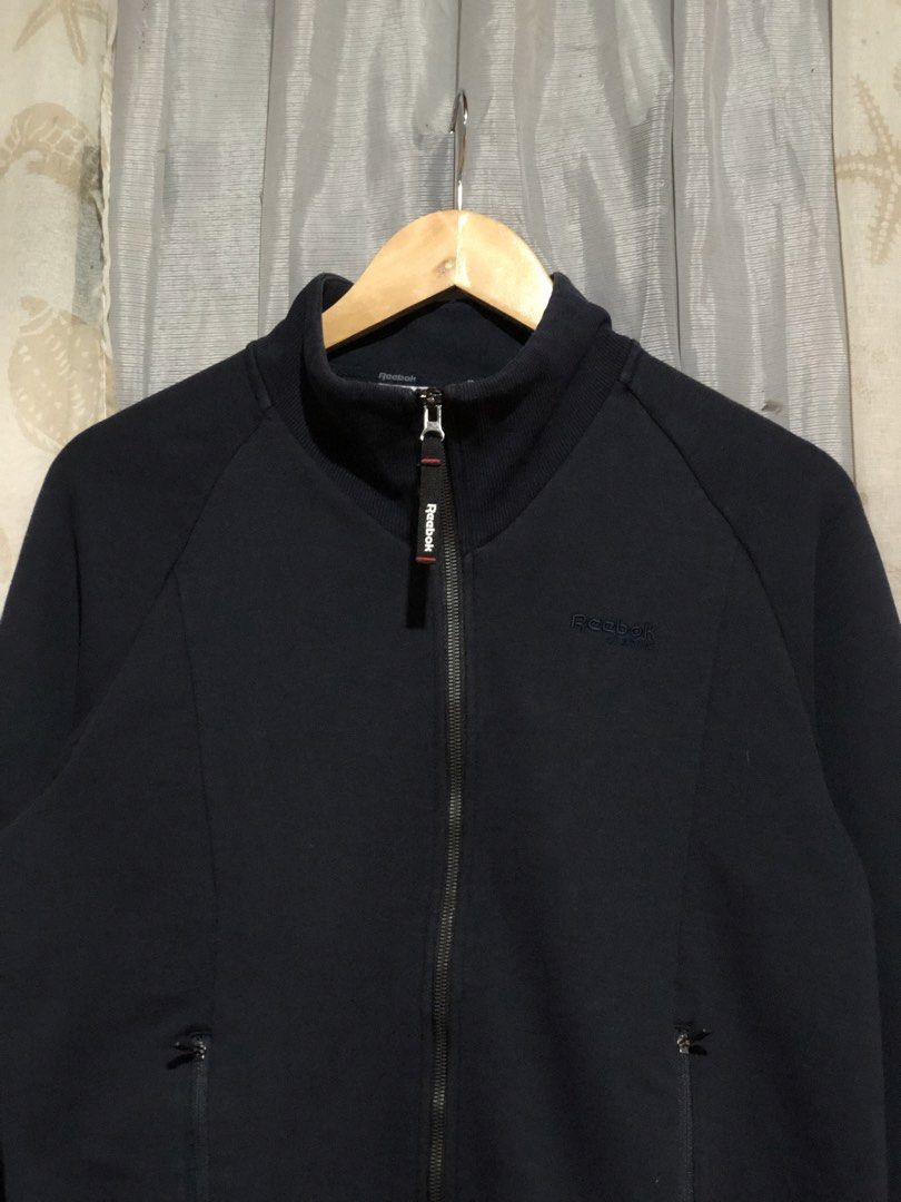 Reebok Classic Forever Full Zip Jacket Dark Blue Size L (Category: Coats, Jackets and Outerwear) located in Calbayog City. Submitted by thriftme.bro (Listing ID 1469324479, Image 2). Description: Dark blue Reebok Classic full zip jacket in size large. Features a high neck, embroidered logo, front zip pockets, and a clean, lightly worn condition. Perfect for cooler weather..