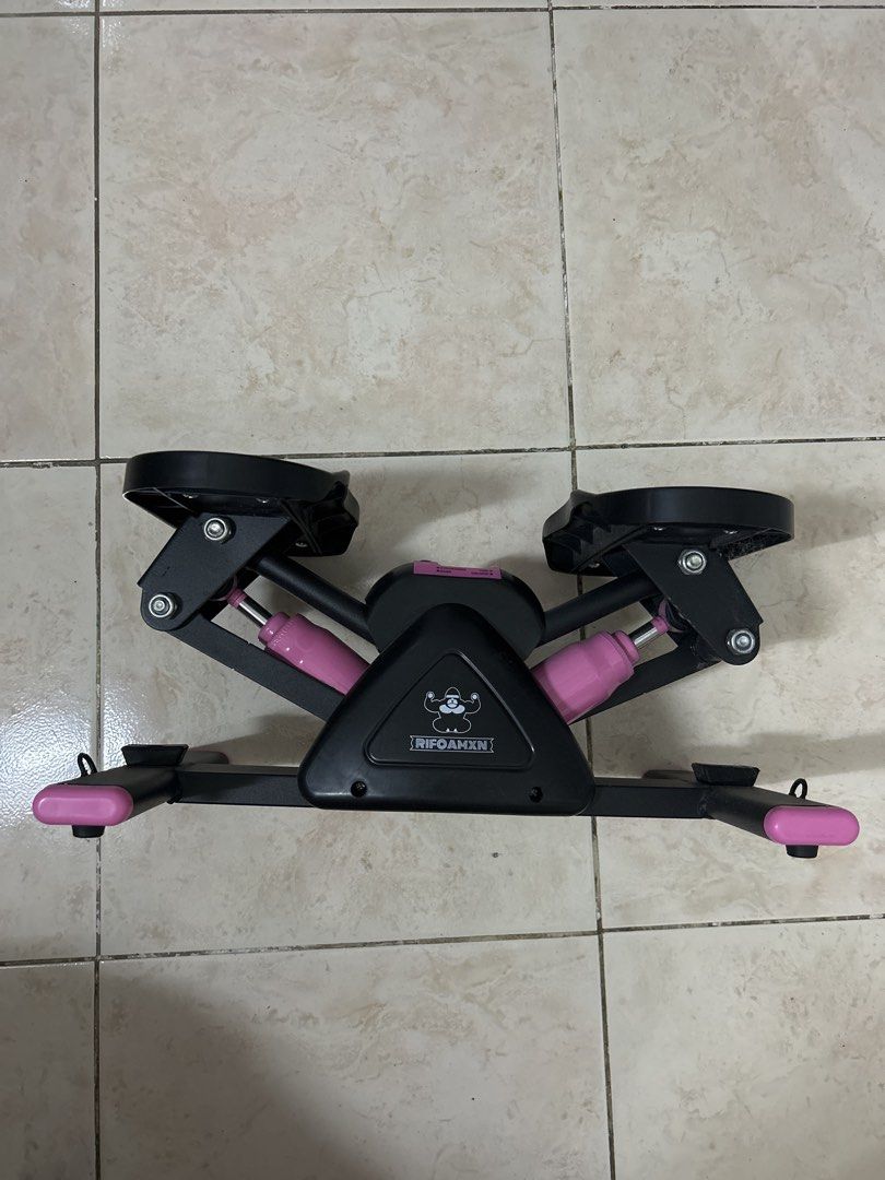 RIFOAMXN Mini Stepper Home Exercise Equipment (Category: Cardio & Fitness Machines) located in Pasig City. Submitted by prewuv (Listing ID 1469292728, Image 1). Description: Black and pink mini stepper from RIFOAMXN. Built-in electronic monitor tracking count, time, calories, and strides per minute. Operates on hydraulic cylinders. Detachable digital monitor display pops out easily for battery changes. Nonslip foot pedals ensure stability during 