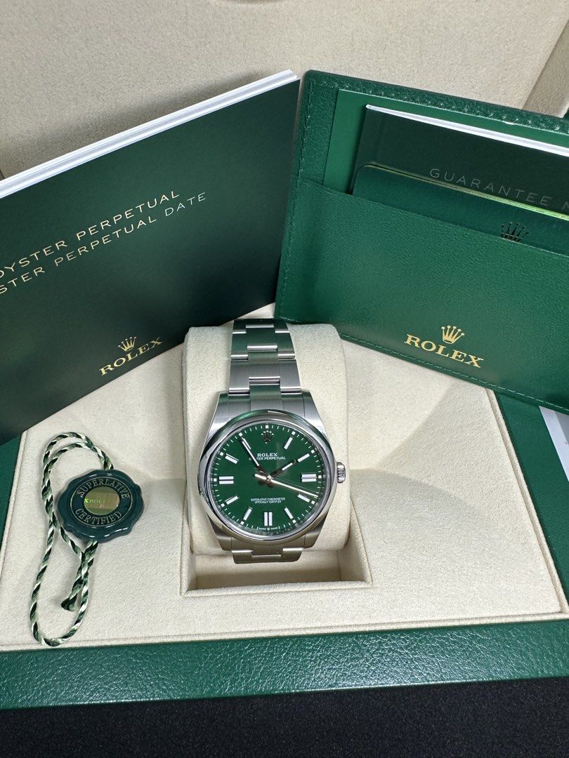 Rolex Oyster Perpetual Green Dial 41MM 124300 (Category: Watches) located in Singapore. Submitted by kckhoo (Listing ID 1469312989, Image 2). Description: - Model: Rolex Oyster Perpetual 41MM -124300 -Feb 2025 set - Dial: Striking Green - Material: Stainless steel case and oyster bracelet - Condition: Brand New/Unworn/Unsized (Sticker still intact as shown in picture) - Includes: Full set (original green presentation box, manuals, warranty paperw