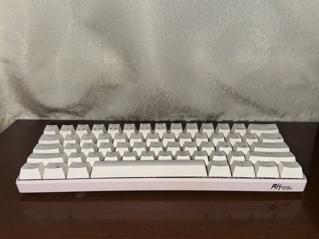 Royal Kludge RK White Mechanical Keyboard (Category: Computer Keyboard) located in Mandaluyong City. Submitted by bobtteok (Listing ID 1469299543, Image 3). Description: - Model: Royal Kludge (RK) 60% Mechanical Keyboard - Color: Clean all-white frame with matching white keycaps and stylish sub-legends - Connectivity: Wired and wireless options available - Performance: Snappy, tactile, and ultra-responsive typing experience - Design: Compact spac