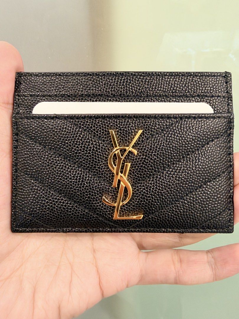 Saint Laurent Monogram Quilted Leather Card Holder (Category: Luxury Bags & Wallets) located in Mandaluyong City. Submitted by k__z__ (Listing ID 1469389594, Image 1). Description: - Brand: Saint Laurent (YSL) - Material: Black grained leather with quilted chevron pattern - Hardware: Gold-tone with iconic YSL monogram - Layout: Multiple card slots on both sides and a convenient middle compartment - Condition: Pristine brand new unused with clean 