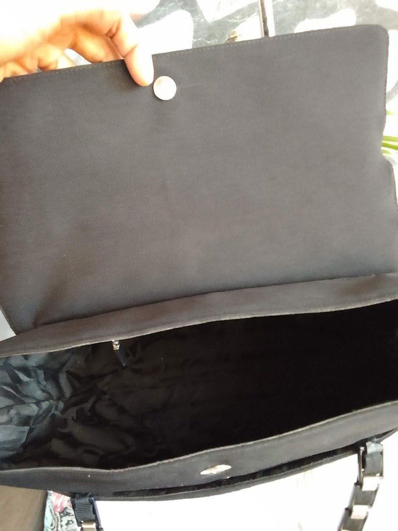 Salvatore Ferragamo Black Canvas Shoulder Bag (Category: Shoulder Bags) located in Bacolod City. Submitted by chuchaystuffs (Listing ID 1469181538, Image 3). Description: - Brand: Salvatore Ferragamo - Material: Durable black canvas with patterned fabric interior lining - Closure: Secure flap with magnetic snap button - Straps: Elegant dual chain and ribbon straps with branded metallic links - Condition: Clean sides with a sturdy, well-maintained