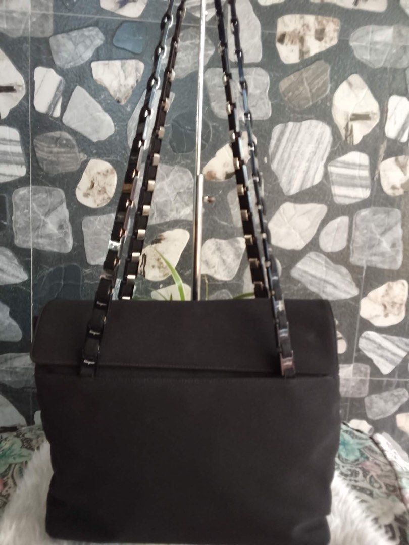 Salvatore Ferragamo Black Canvas Shoulder Bag (Category: Shoulder Bags) located in Bacolod City. Submitted by chuchaystuffs (Listing ID 1469181538, Image 1). Description: - Brand: Salvatore Ferragamo - Material: Durable black canvas with patterned fabric interior lining - Closure: Secure flap with magnetic snap button - Straps: Elegant dual chain and ribbon straps with branded metallic links - Condition: Clean sides with a sturdy, well-maintained