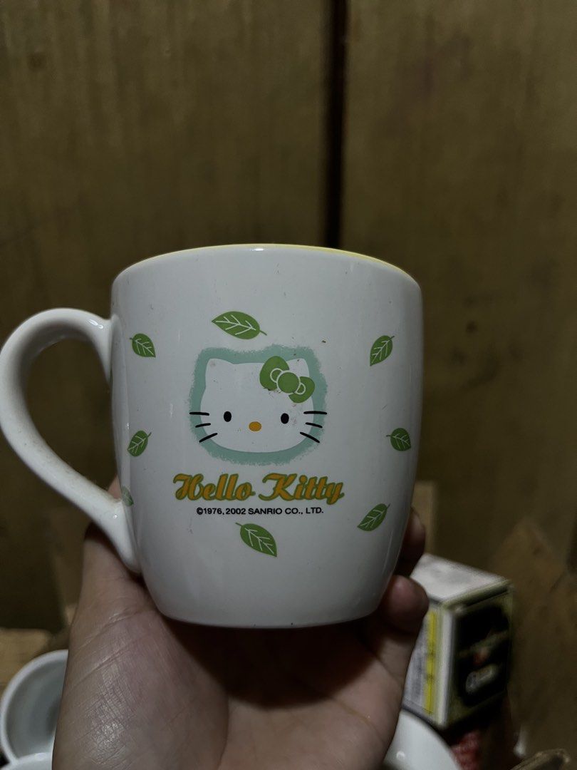 Sanrio Hello Kitty 2002 Green Leaf Ceramic Mug (Category: Coffee & Tea Tableware) located in Manila. Submitted by janetecson05 (Listing ID 1469251313, Image 2). Description: - Official Sanrio merchandise (dated 1976 & 2002) - Cute design featuring Kitty with fairy wings and green leaves - Stylish yellow interior rim - Comfortable C-handle for easy grip - Perfect addition to any Kitty or Sanrio collection.