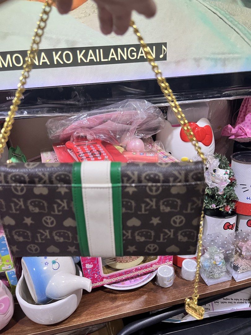 Sanrio Hello Kitty Monogram Wallet with Chain Strap (Category: Wallets & Card holders) located in Manila. Submitted by janetecson05 (Listing ID 1469194414, Image 2). Description: HK VIVITIX LONG WALLET - Authentic Sanrio Kitty long wallet - Chic brown monogram print with a sporty green & white center stripe - Luxurious gold metallic interior lining with multiple card slots and compartments - Secure snap button closure - Includes a detachable gold
